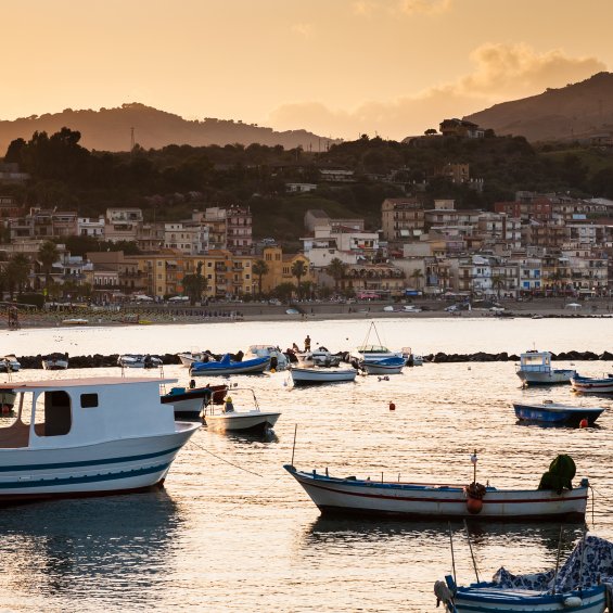 Vista di Giardini Naxos dal mare con pescherecci, provincia di Messina, Sicilia, Italia